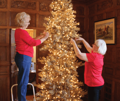  Volunteers Marilyn Auberle and Patsy Ramsay decorate a Christmas tree at Meadow Brook.  