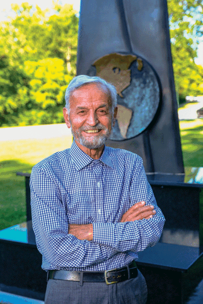  Kegham Tazian stands with his installation, “Pyramid Earth,” in Linden Park.  