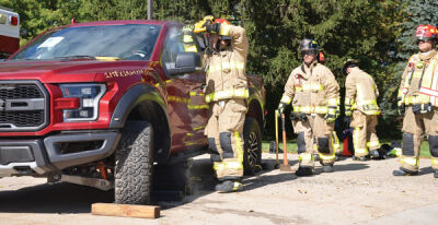  Macomb Township firefighters demonstrate hydraulic extrication tools on a donated Ford Raptor at the department’s open house on Oct. 8. 