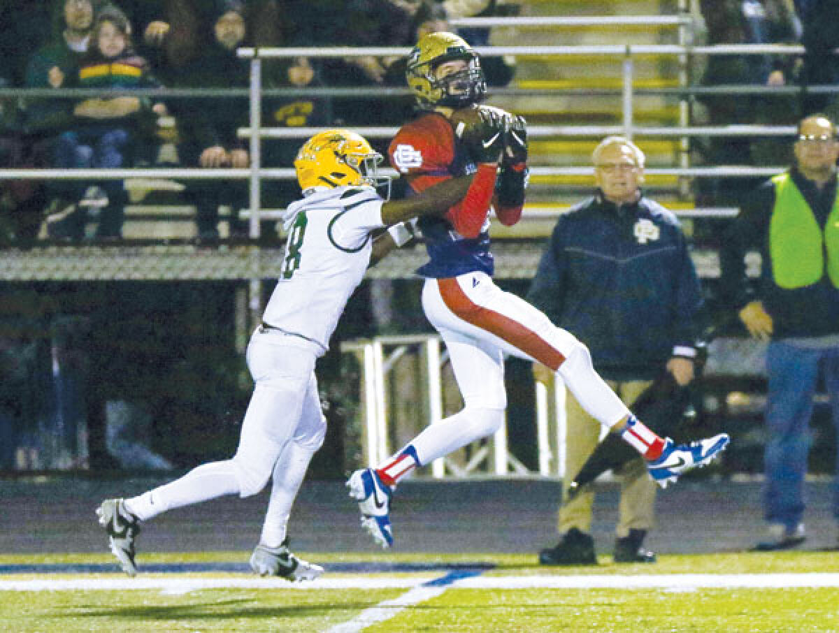  Grosse Pointe South senior wideout Karter Richards hauls in a catch with Grosse Pointe North defensive back Martez Jones in coverage. 