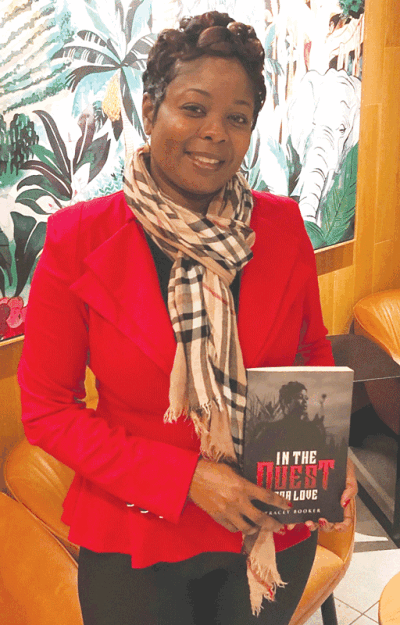  Grosse Pointe Farms resident Tracey Booker holds a copy of her book, “In the Quest for Love,” which explores the issue of domestic violence. 