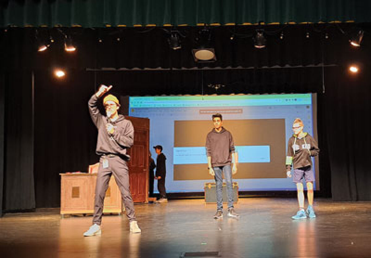  Joseph Green, left, the auditorium manager and technical director for the Novi Middle School play “Eureka! Science and Invention,” gives directions to the stage crew regarding lighting for a scene as actors Rachit Naik, 13, and Kian Rabourn, 14, stand by during a technical rehearsal Oct. 20. 