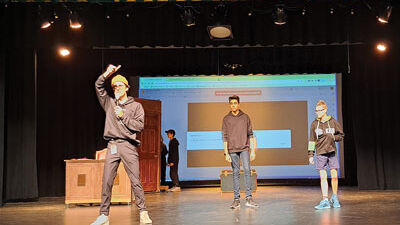  Joseph Green, left, the auditorium manager and technical director for the Novi Middle School play “Eureka! Science and Invention,” gives directions to the stage crew regarding lighting for a scene as actors Rachit Naik, 13, and Kian Rabourn, 14, stand by during a technical rehearsal Oct. 20. 