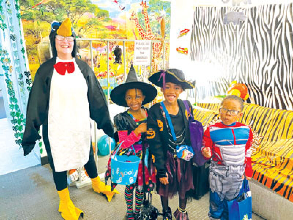  From the left, Jas Thomas, of Detroit; Kaylee Rushon, of Detroit; and Gee Carver, of Pontiac, were among the trick-or-treaters at the Blood Cancer Foundation of Michigan’s Halloween event at Embassy Suites of Troy Oct. 13. They received candy from Caroline Nellist, a foundation volunteer, far left. 
