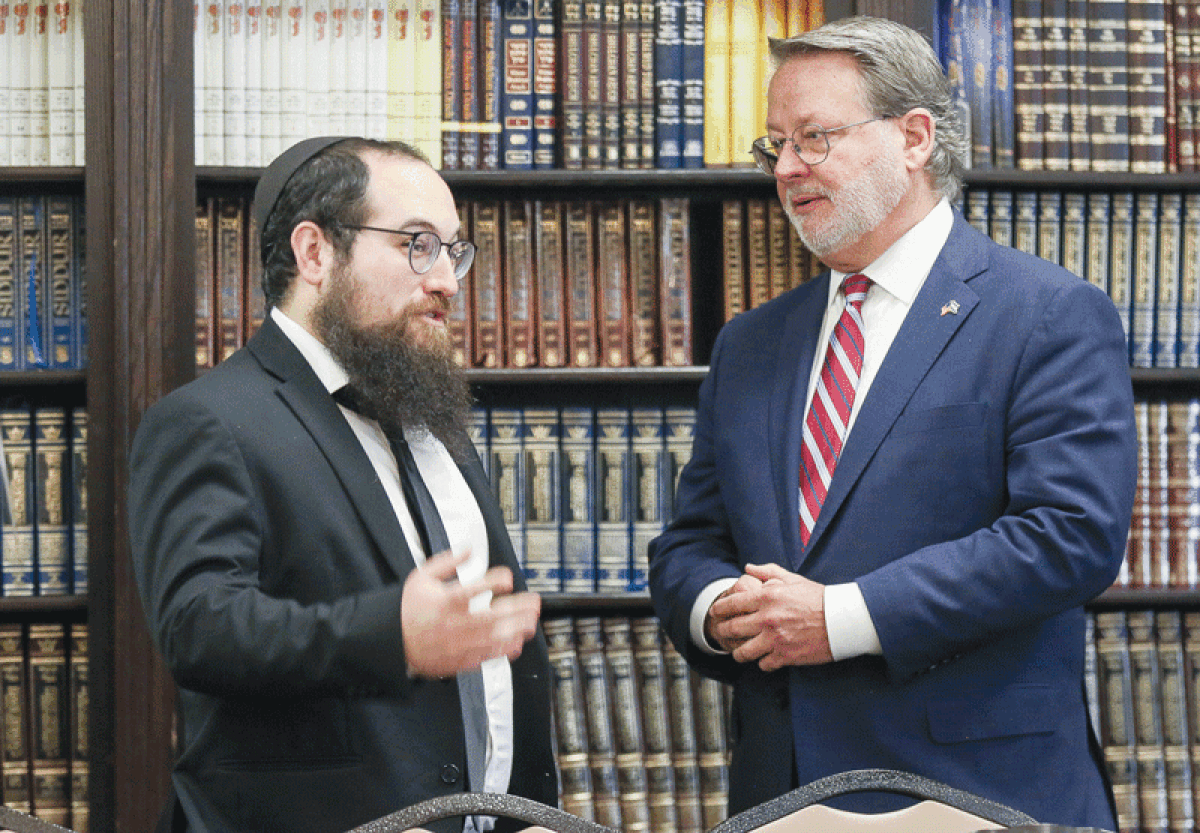  Rabbi Mendel Polter talks with Sen. Gary Peters about the Woodward Avenue Shul, which was the beneficiary of a security grant, Oct. 12. 