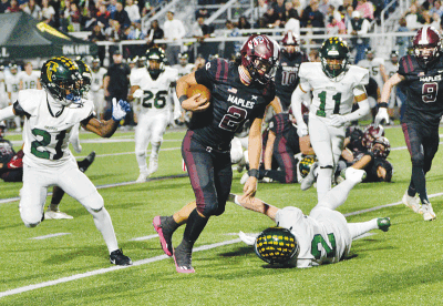  Seaholm senior quarterback Colton Kinnie runs through the Groves defense. 