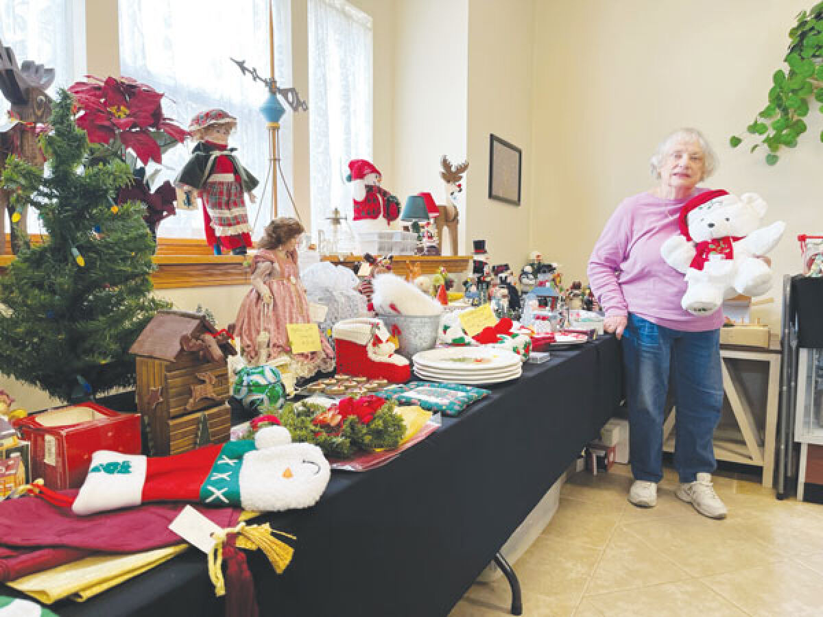  Marilynn Wright, chair of the Baumgartner Museum, stands with some of the items that will be for sale at its Christmas open house on Sunday, Dec. 3. 