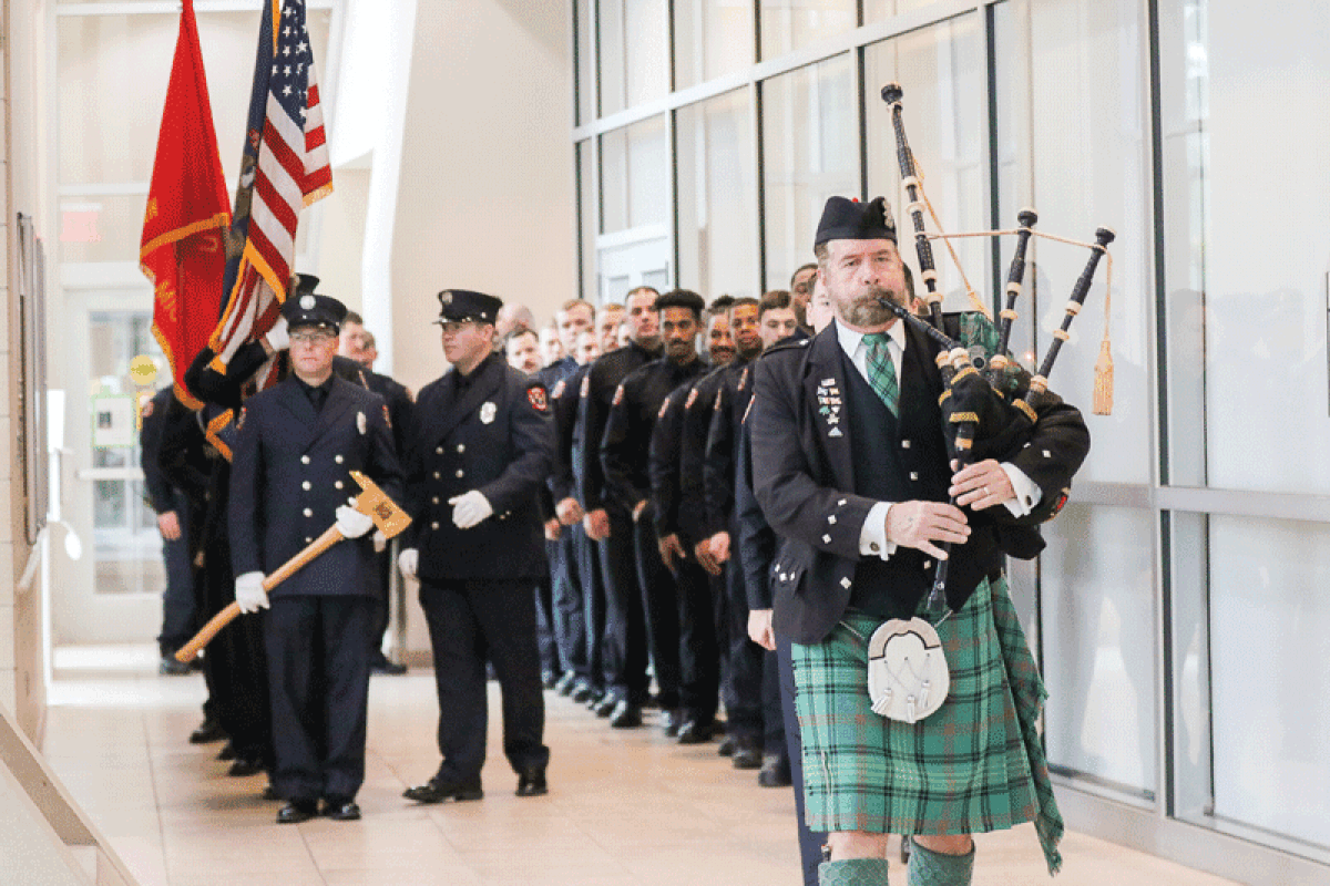  Bagpiper Donald Ross leads members of the Warren Fire Department, cadets and new hires into the atrium at City Hall. 