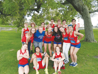  The Warren Cousino cross-country program takes a team photo. 