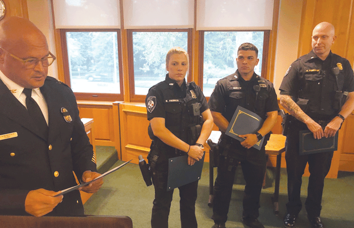  From left, Grosse Pointe Park Public Safety Director James Bostock presents officers Korrine Farmer and Esho Matty, and Lt. Colin Connaire, with an award during a Sept. 11 Park City Council meeting. 