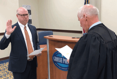  From left, attorney David Draper is sworn into office as Grosse Pointe City’s new municipal court judge by retiring Judge Russell Ethridge Nov. 13 inside the courtroom, as dozens of family members and friends look on. 