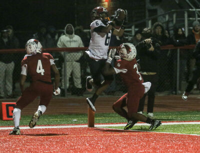  Southfield A&T senior wideout Jawon Jarrett makes a touchdown grab over a Chippewa Valley defender.  