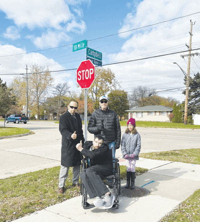  Former Warren Mayor James Fouts dedicated a street in honor of Jason Dunn, center, photographed with dystonia awareness advocate Mike Delise and his 8-year-old granddaughter, Sylvia Spadafore.  