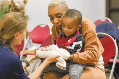  Toi Kenzo, from Shelby Township, and son Creel, 2, hold a pied ball python named Viserion 