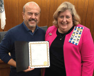  Grosse Pointe Farms Mayor Louis Theros presents Deann Newman, Louisa St. Clair Chapter National Society Daughters of the American Revolution America 250 chair, with a proclamation acknowledging an America 250 Patriots marker for Joy Bells during an Oct. 9 City Council meetin 