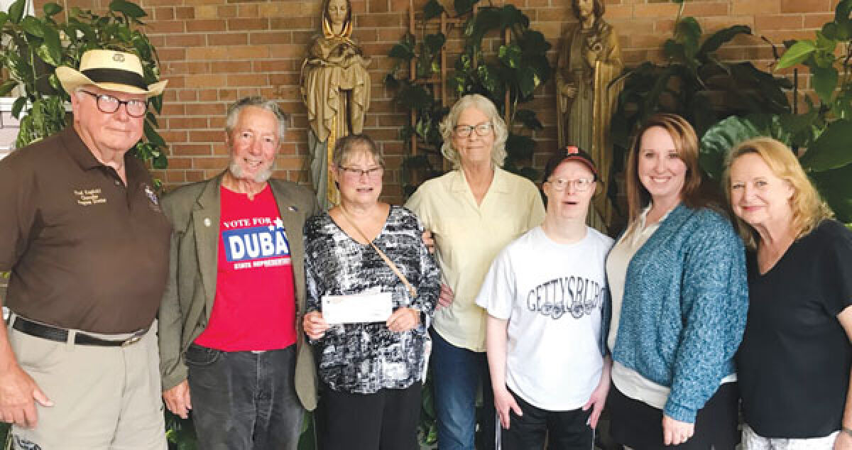  Several community members were on hand for a donation from the Knights of Columbus Father Solanus Casey Council to the Parents Who Care nonprofit on July 13.  