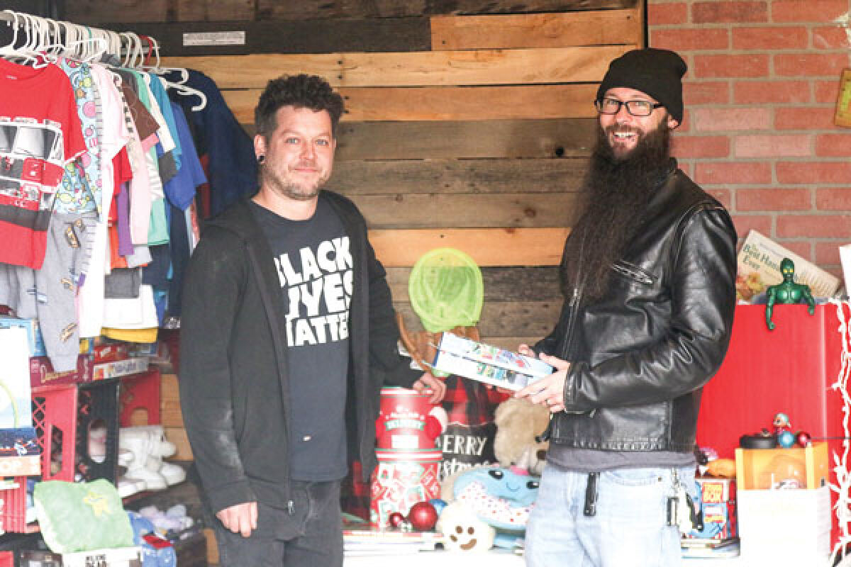  Tim Kniaz, left, with help from volunteers like John Hofmann, right, will open the FreeStore Holiday Pop-Up Shop from 10 a.m. to 4 p.m. Dec. 9-10 at a building space located at 21339 Gratiot Ave., located next to the Villa Restaurant.  