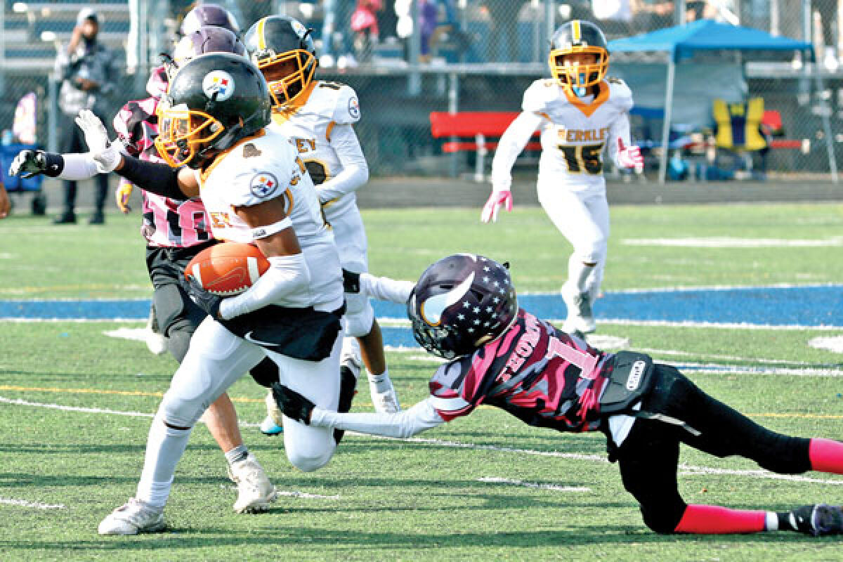  Berkley Steelers running back Cameron Madison carries the ball during the Oakland/Macomb Youth Football Association Super Bowl on Nov. 5 at Hurley Field in Berkley. 