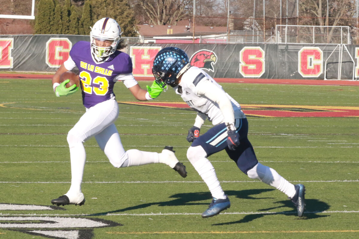  Warren De La Salle junior wideout Phoenix Glassnor attempts to evade a Waterford Mott defender. 