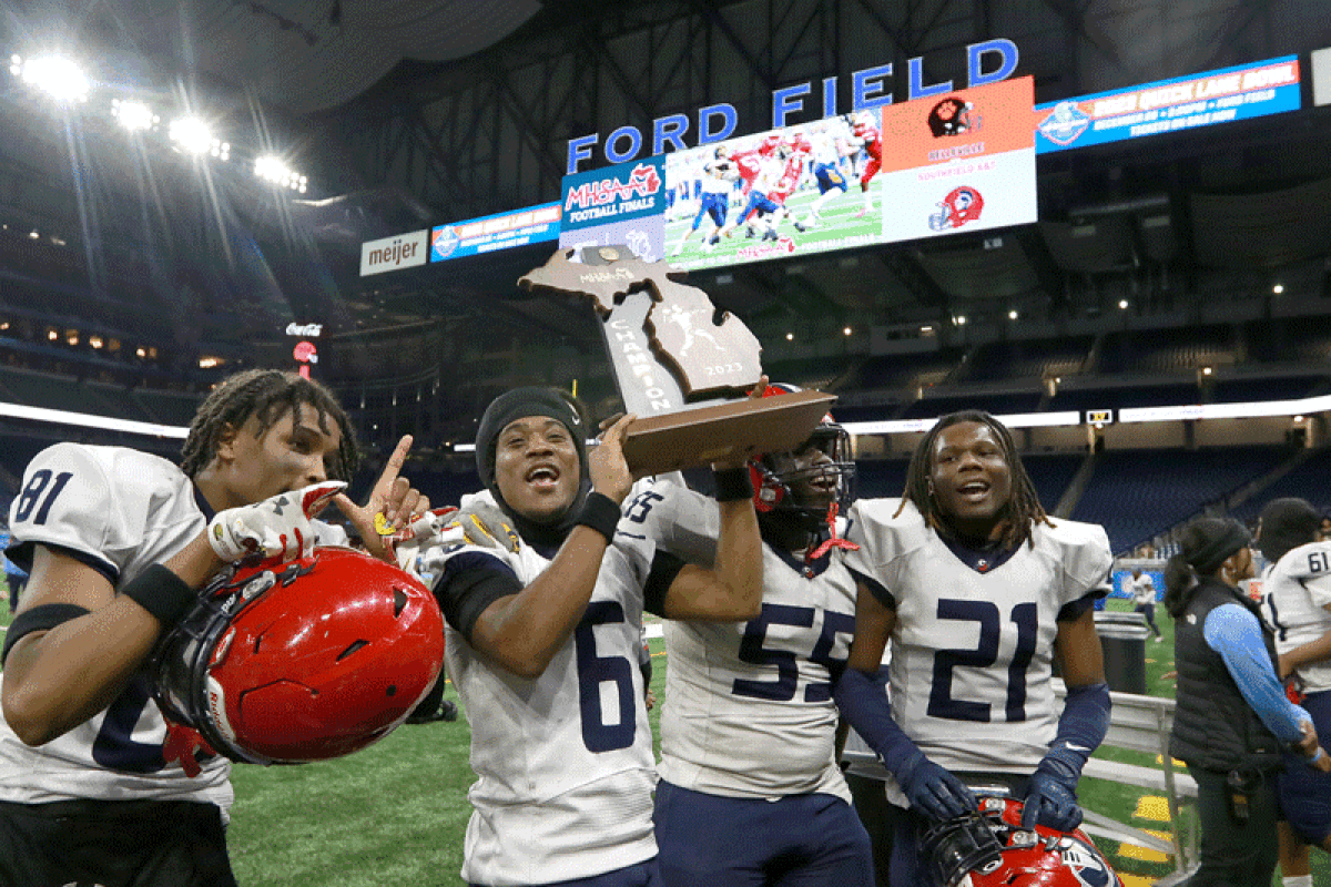  Southfield A&T players hoist the Michigan High School Athletic Association Division 1 State Finals trophy. 