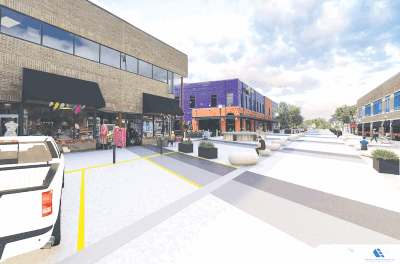  This is a rendering of the redesigned Macomb Place as part of the Mount Clemens Downtown Revitalization Project. The road is level for a better pedestrian experience with movable planters and boulders separating the pedestrian-only areas from space in which vehicles will traverse. Hydraulic bollards will be placed at either end of the street to block vehicle access as desired. 