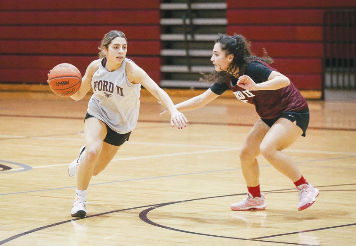  Senior Lilah Earl dribbles the ball during a team practice Nov. 30 at Utica Ford II High School. 