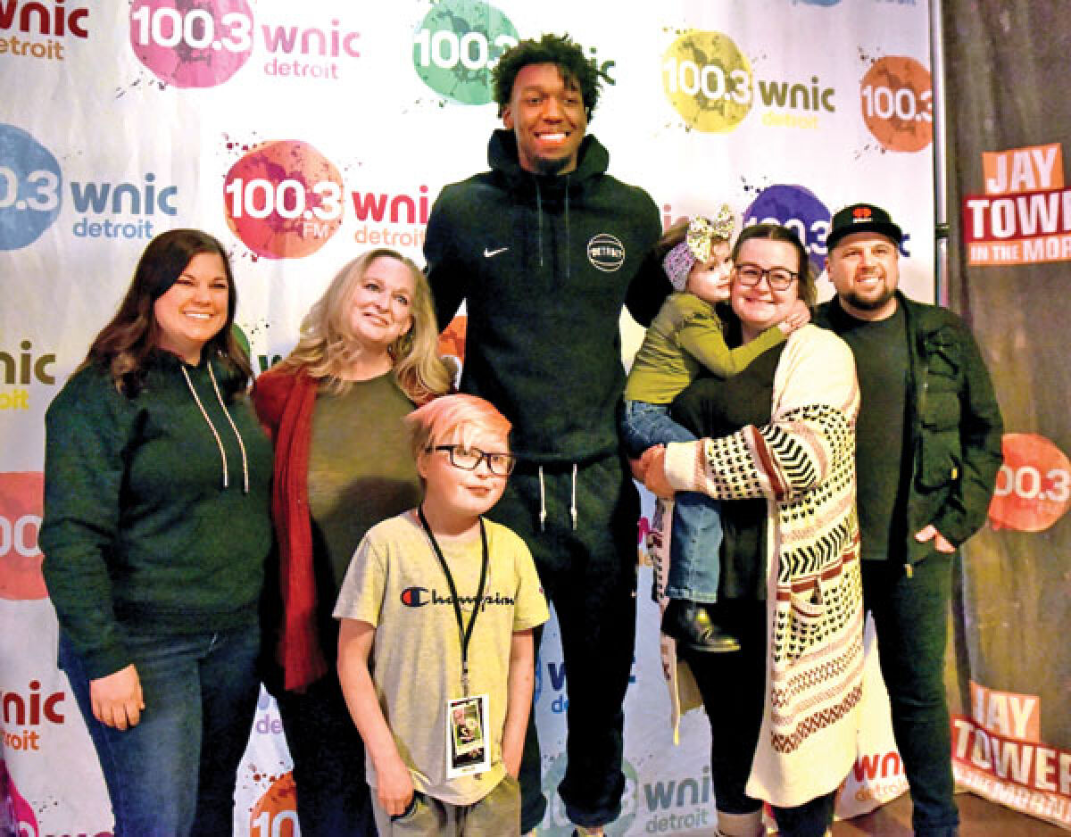  Skyler Pfromm, 14, of Clinton Township, and his family take a photograph with Detroit Pistons center James Wiseman and broadcaster Jay Towers at Emagine Royal Oak Nov. 28. 