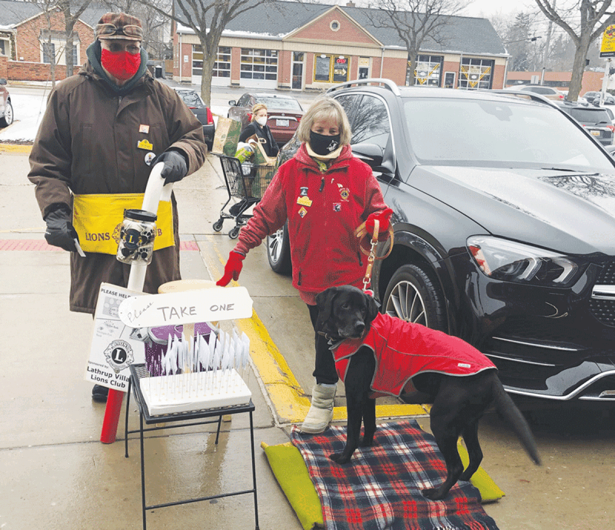  Lions Club members Dick and Nancy Maxwell collect with Leader Dog Chase.  