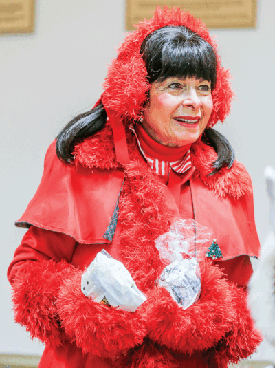  Grosse Pointe Shores resident Toni Urso-Salvador — seen here portraying Christmas Carol for the Lighting of the Village in the Shores in November 2022 — continues to play the character each year during the holidays. 