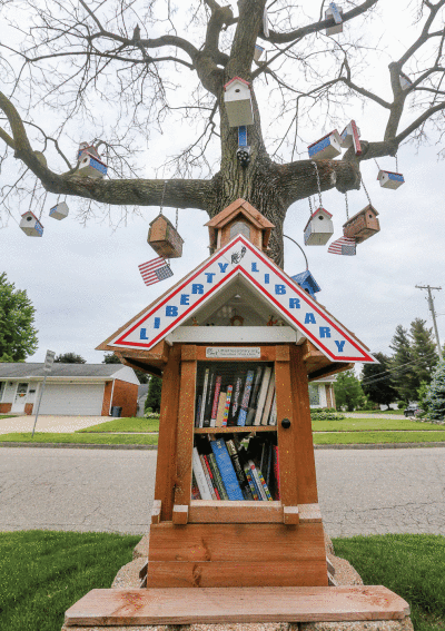  A Little Free Library, aka the Liberty Library, stands near Wagner’s home, as well as a dead tree decorated with birdhouses. 