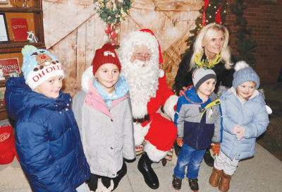  Children pose with Santa at a past  St. Peter Catholic Church and St. Mary Catholic School Christmas Extravaganza. 