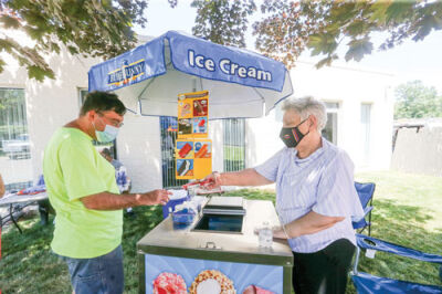  Nora, who has been a member of the Easterseals Michigan Dreams Unlimited Clubhouse since 1995, works the ice cream station during the 30th anniversary open house June 21. 