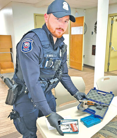  Southfield Police Officer Dylan Hayes works last year’s gun buyback event.  