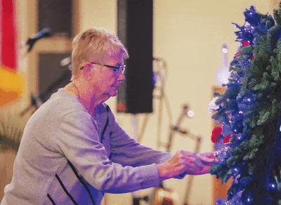  Keynote speaker Debbie Nagle places a flower on a wreath in honor of her daughter, Jessica Nagle-Wilson, a Hazel Park police officer who was killed in the line of duty on July 28, 2002. 