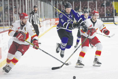  Motor City Rockers defenseman Jameson Milam goes airborne to get past the Port Huron Prowlers defenders. 