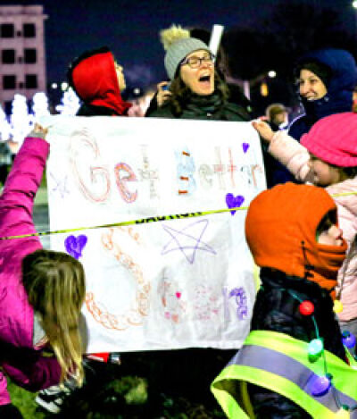  Supporters hold up a sign for the kids. 