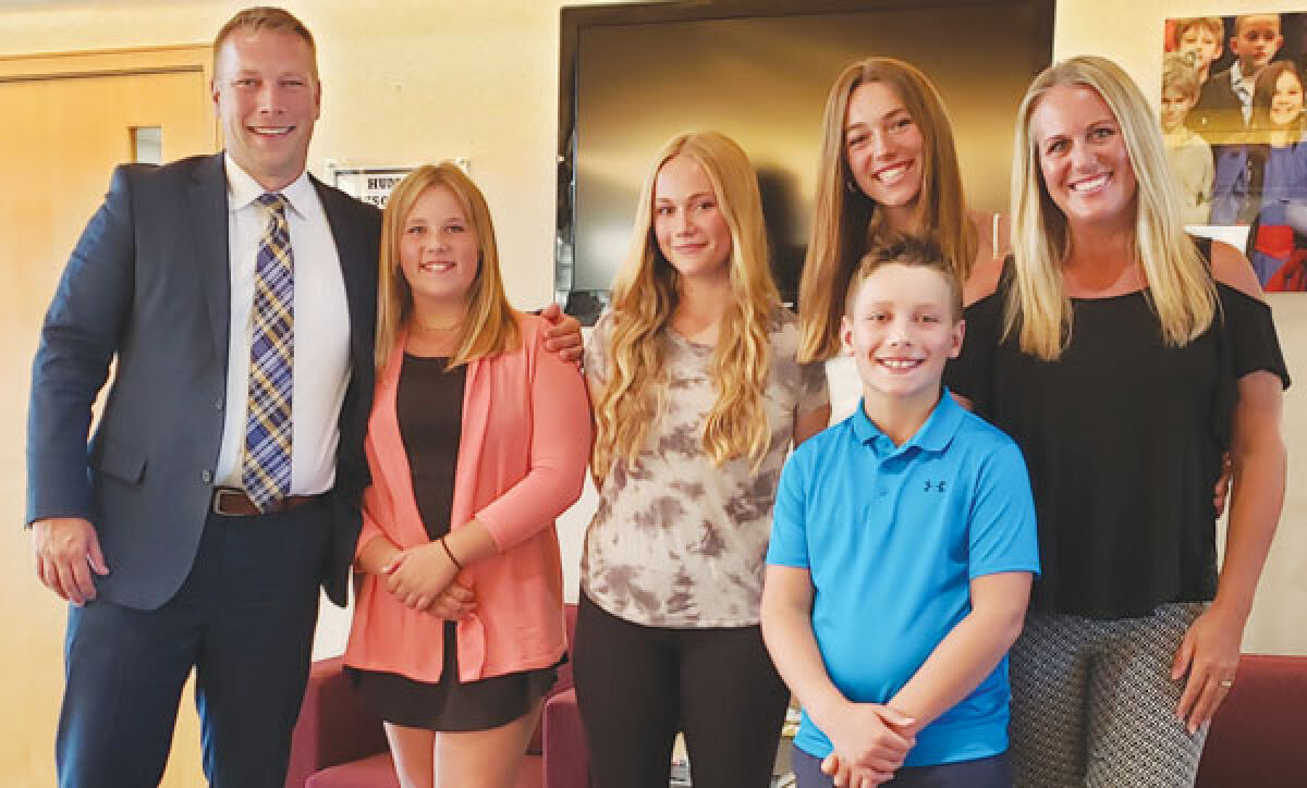  Ben Mainka, the new superintendent of the Novi Community School District, poses with his family at the Novi Community Schools Educational Services Building after the school board approved his contract July 14. Pictured from left are Mainka; his daughters Arianna, Alyssa and Abigail; his son Alex; and his wife Jennifer.  