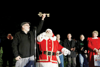  Utica Mayor Gus Calandrino presents Santa Claus with the key to the city Dec. 9 during the Downtown Utica Christmas Tree Lighting Celebration. 