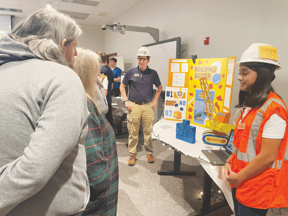  Utica Community Schools Center for Science and Industry students present the products that they designed to be viable and sellable to professionals and peers at the Motor City Trade Show Dec. 5. 