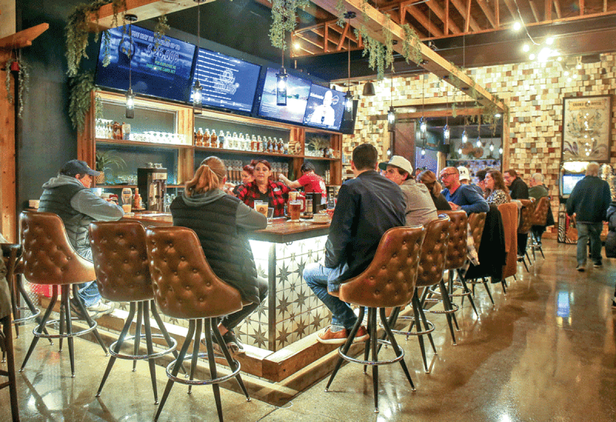  Patrons at Grand River Brewery dine at the bar during its grand opening. 