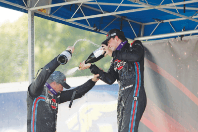  Nolan Allaer and his father, Robert Allaer, celebrate finishing first and second at the 2023 Formula  Continental Runoffs on Sept. 30 at Virginia International Raceway. 
