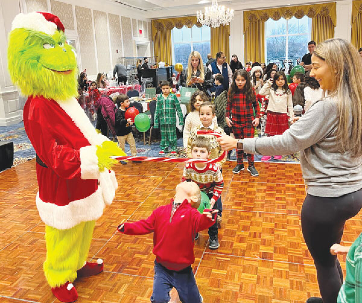  Kids at the “Breakfast in Whoville” fundraiser Dec. 3 got to help out a good cause while having some fun, like limboing with the Grinch. 
