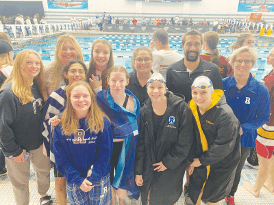  Aaron Helander stands with his Rochester High School girls swim and dive team. 