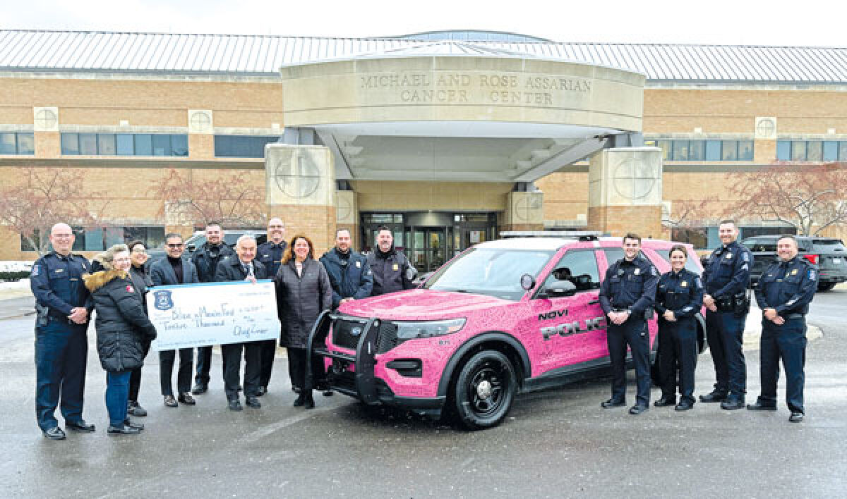 Members of the Novi Police Department — including Chief Erick Zinser, left, police clerk Kim Kleimola, Assistant Chief Scott Baetens, Lt. Brian Woloski, Cmdr. Kristie Gruenwald and Cmdr. Jason Meier, and several others — present a check for $12,000 to officials with the Assarian Cancer Center at Ascension Providence Hospital, Novi Campus, Nov. 27 for the Believe in Miracles Fund. 