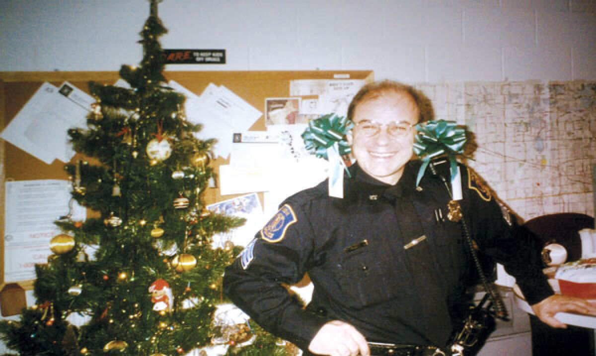  Former Mayor Bob Gatt smiles with bows on each ear as he enjoys a Novi Police Department Christmas party circa 1991. 
