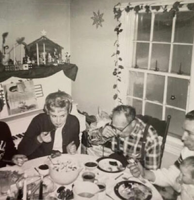  Kathy Crawford, wearing the dark sweater, gathers with her family in the dining room during Christmas in the area of 12 Mile and Haggerty roads in the early 1960s. She and her grandmother would play Christmas carols on the piano. 