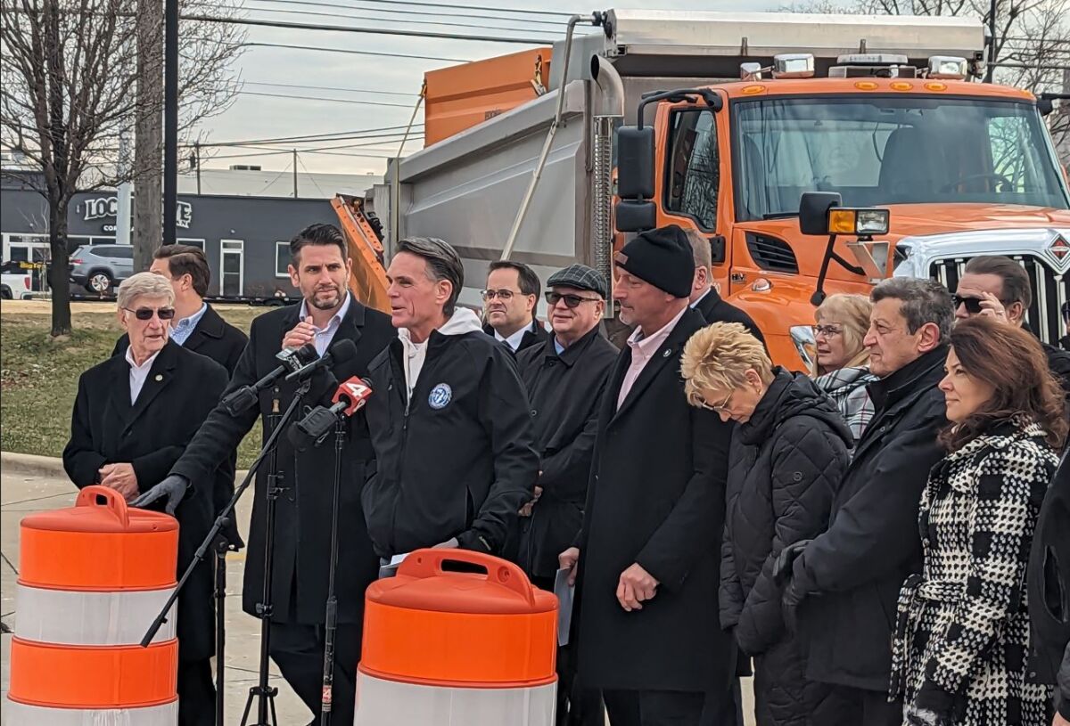  Surrounded by local officials and stakeholders, Macomb County Executive Mark Hackel speaks at a Dec. 20 press conference in Sterling Heights, which celebrated the completion of roadwork along Mound Road. 