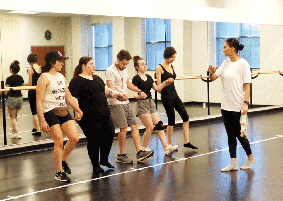  Dance instructor Allena Berger, right, teaches a Middle Eastern line dance at the Sterling Heights Community Center June 11. 