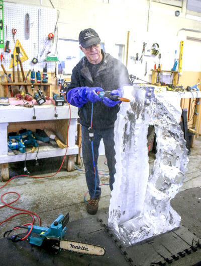  Jeff Wolf, ice sculptor from Finesse Ice, works on a sculpture for the Aqua Freeze Festival. 