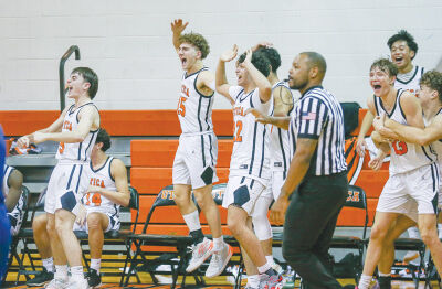  Utica celebrates a dunk by senior Blake Dean before the end of the 79-47 win over Warren Woods Tower on Dec. 21 at Utica High School. 